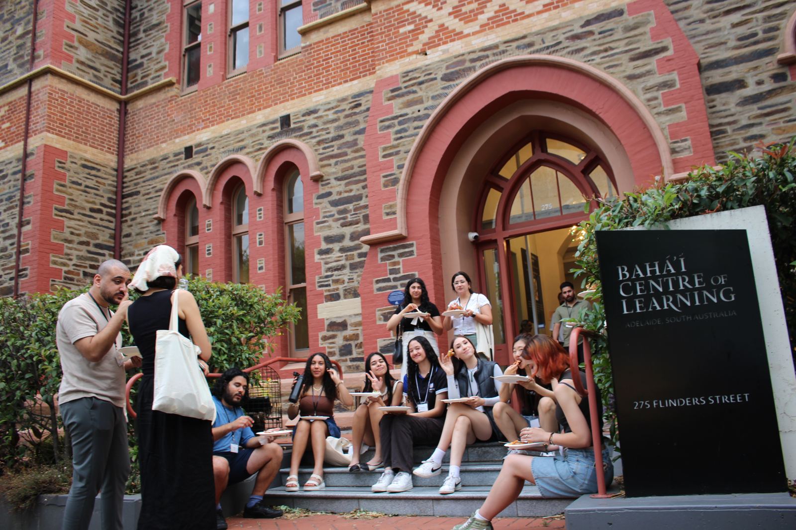 Youth on the front steps of the Bahá'í Centre of Learning, 275 Flinders Street